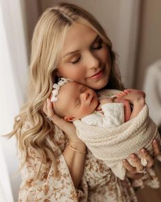 a woman holding a baby in her arms