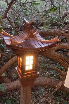 a wooden lantern is lit up in the woods