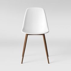 a white chair sitting on top of a wooden floor