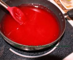 red liquid being stirred in a pan on the stove