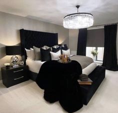 a black and white bedroom with chandelier