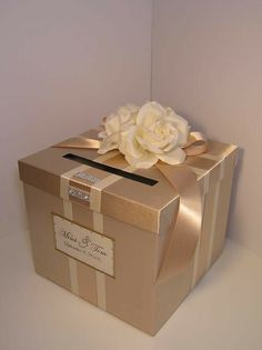 a gift box with a white rose on top