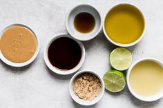 five bowls filled with different types of condiments