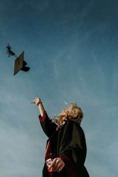 a woman flying a kite in the sky