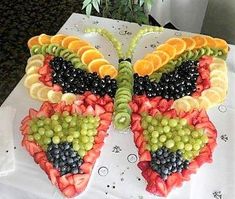 a butterfly made out of fruit on top of a table