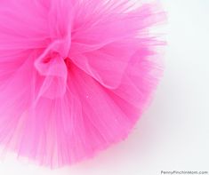 a pink tulle ball sitting on top of a white table