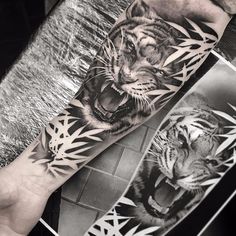 black and white tiger tattoo on the arm