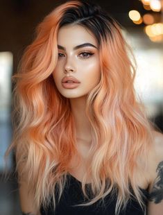 The peach ombre look with dark roots offers a more natural take on peach hair color, blending darker roots with a gradient of peachy tones towards the ends. This style adds depth and dimension to the hair while maintaining a soft and subtle look. It’s perfect for those who want a low-commitment way to try peach hair without having to worry about frequent touch-ups. This style works well with round and oval face shapes and pairs beautifully with brown or hazel eyes. Peach Bellini Hair, Pastel Hair With Dark Roots, Peachy Hair Color Rose Gold, Peach Hair Dark Roots, Hair Color For Yellow Undertones, Peach Brown Hair, Multi Tone Hair, Multi Tone Hair Color, Peachy Hair Color