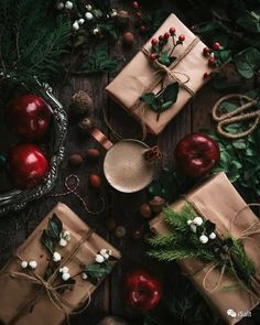 presents wrapped in brown paper and tied with twine, surrounded by christmas greenery