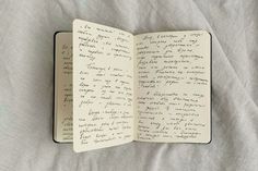 an open notebook with writing on it