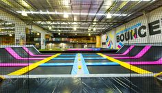 an indoor trampoline park with colorful obstacles