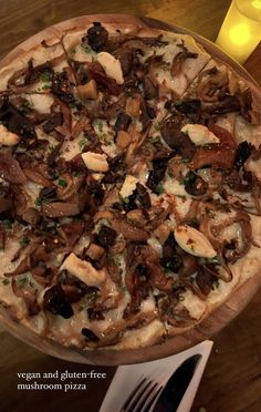 a pizza sitting on top of a wooden table