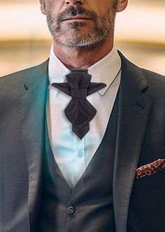 "Introducing the \"Vertex\" - a distinctive, handcrafted, luxury bow tie, exclusively designed for the discerning gentleman seeking to make a timeless statement. Meticulously crafted with a keen eye for detail, this black masterpiece boasts an original, striking design. Characterized by its sharp, pointed corners and tops, the Vertex exudes an air of sophistication, making it an ideal accessory for formal occasions. Its refined linear texture adds an extra touch of elegance, ensuring it stands o Dapper Suit And Tie Accessories For Father's Day, Elegant Formal Ties For Father's Day, Elegant Ties With Pocket Square For Father's Day, Elegant Black Tie For Father's Day, Elegant Ties For Black-tie Events, Elegant Black Tie Pocket Square, Dapper Ties With Pocket Square For Black Tie Events, Elegant Ties With Pocket Square For Black-tie Events, Luxury Ties For Black Tie Events