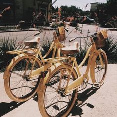 two yellow bicycles parked next to each other