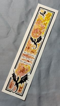 a bookmark with an image of a dragon and the words my house, my children, my woman on it