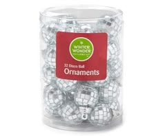 white and silver christmas balls in a clear plastic container with red label on the top