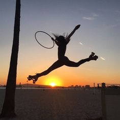 a woman jumping in the air with a tennis racquet on top of her head