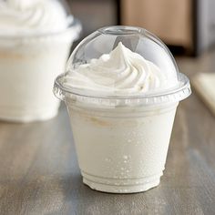 there are two cups with whipped cream in them