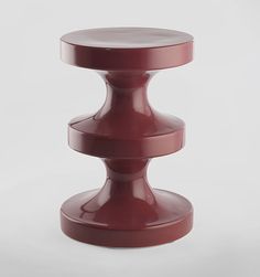 a pink stool sitting on top of a white floor