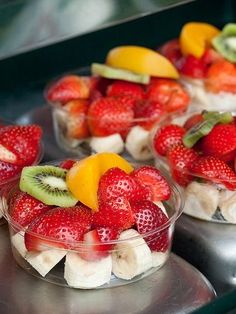 fruit salad in small plastic bowls on a table