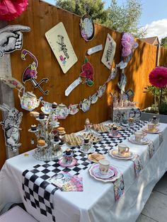 a table set up with tea cups and plates for afternoon tea party guests to enjoy