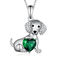 a dog with a heart shaped emerald necklace