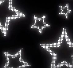 some white stars on a black background with light up letters in the shape of arrows