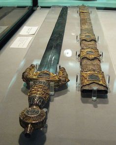 two swords on display in a glass case