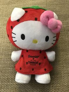 a hello kitty stuffed animal wearing a red dress