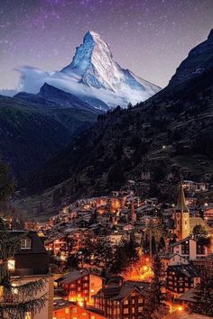 a night view of a town with a mountain in the background