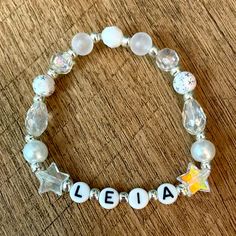 a beaded bracelet with the name aleia written in white beads and clear glass beads