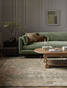 a living room with a green couch and coffee table