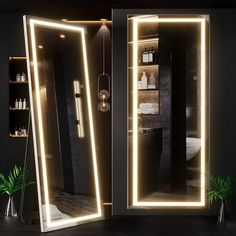 an illuminated bathroom mirror in the shape of a double door with lights on each side