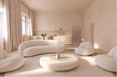 a living room filled with white furniture and lots of light coming in from the windows