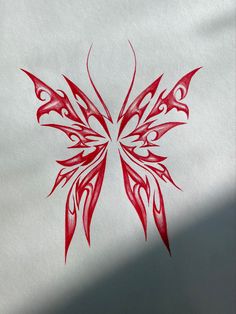 a drawing of a red butterfly on white paper