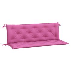 a pink futon sofa with ties on the armrests and back rest, in front of a white background