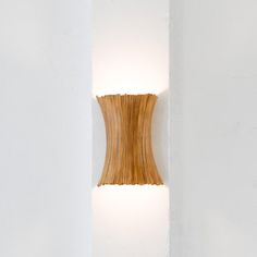 a light that is on the side of a wall with a wooden object in it