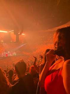 a group of people standing in front of a crowd at a concert