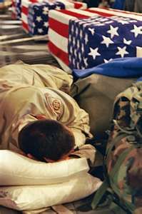 a man sleeping on the ground in front of american flags