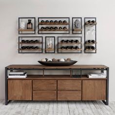 a wooden table topped with lots of shelves filled with bottles and bowls on top of it