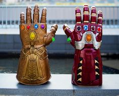 two iron man gloves sitting next to each other