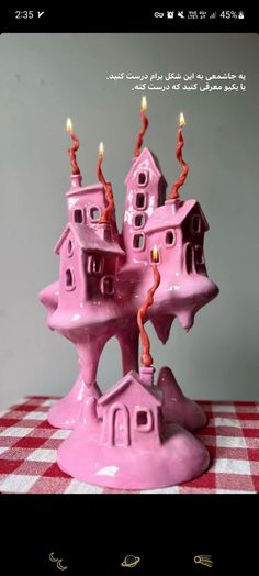 a pink castle candle holder sitting on top of a table