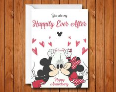 a greeting card with mickey and minnie kissing