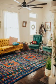 a living room filled with furniture and a ceiling fan