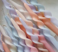 several toothbrushes are lined up in a box with pastel colors on them