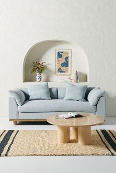 a living room with a blue couch and coffee table