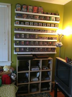 a living room filled with furniture and a flat screen tv sitting on top of a wooden shelf