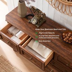 the drawers are open to reveal towels and other items in their storage compartment, along with an alarm clock