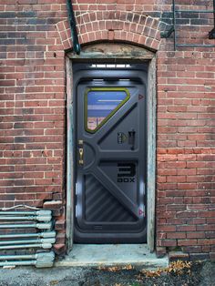 an open door on the side of a brick building