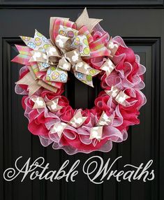 a red and pink wreath on a black door with the words potato wreaths written below it